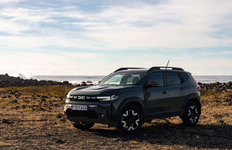 Dacia Duster 4x4 SUV parked on a rocky coastline in Iceland