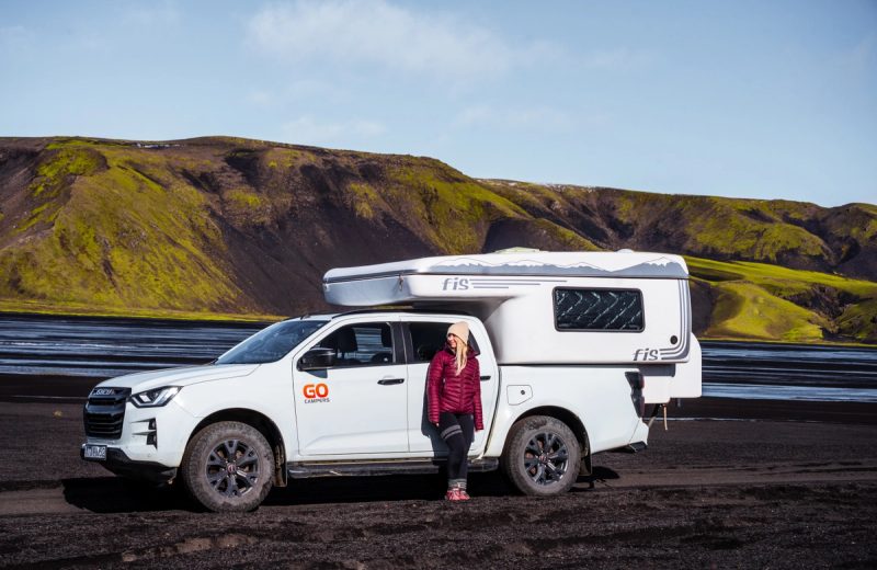 Go 4x4 PRO automatic Highland campervan parked on black volcanic sand beside a river in Iceland