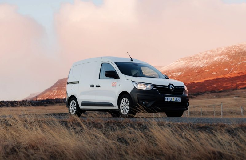 Go SMART 2-person heated compact campervan on a road below sunlit mountains in Iceland