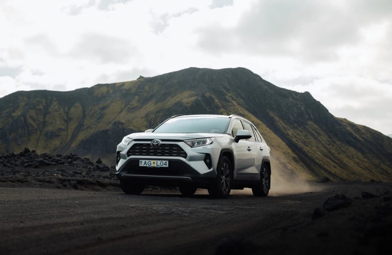 Toyota RAV4 4x4 automatic SUV driving on a volcanic gravel road in the Icelandic Highlands