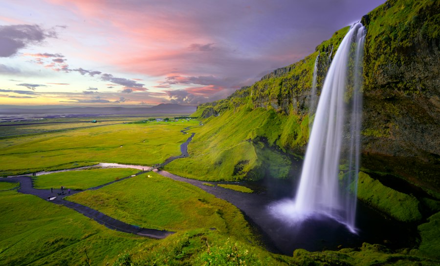 Skógafoss waterfall plunging 60 meters over mossy cliffs on the South Coast